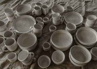 Beautiful collection of ceramic tableware arranged on a textured cloth, perfect for home decor inspiration.