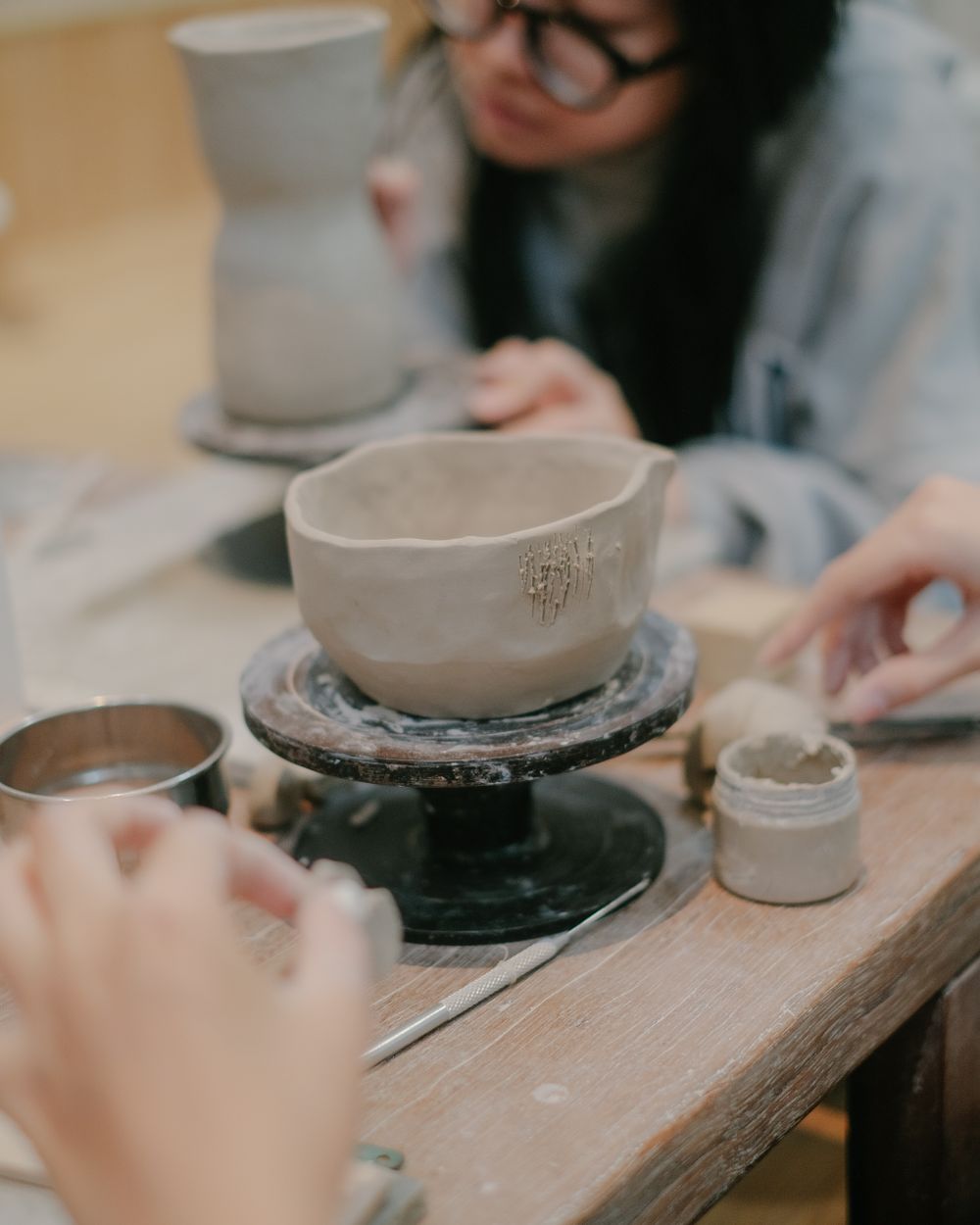 Student throwing clay