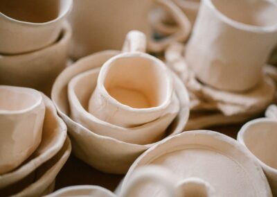 Close-up shot of handmade clay pottery showing unique, artistic shapes.